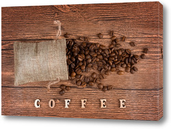   Постер Black coffee foil packaging bag on wooden table top view. Spilled beans flat lay concept. Room for text.
