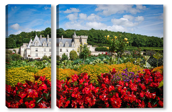  Замок Юссе, долина Луары, Франция летним солнечным днем на фоне цветущих красных георгинов