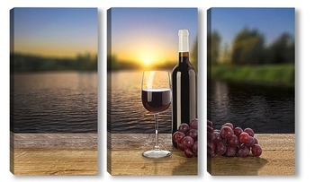 Модульная картина Бутылка красного вина, виноград и бокал на фоне заката